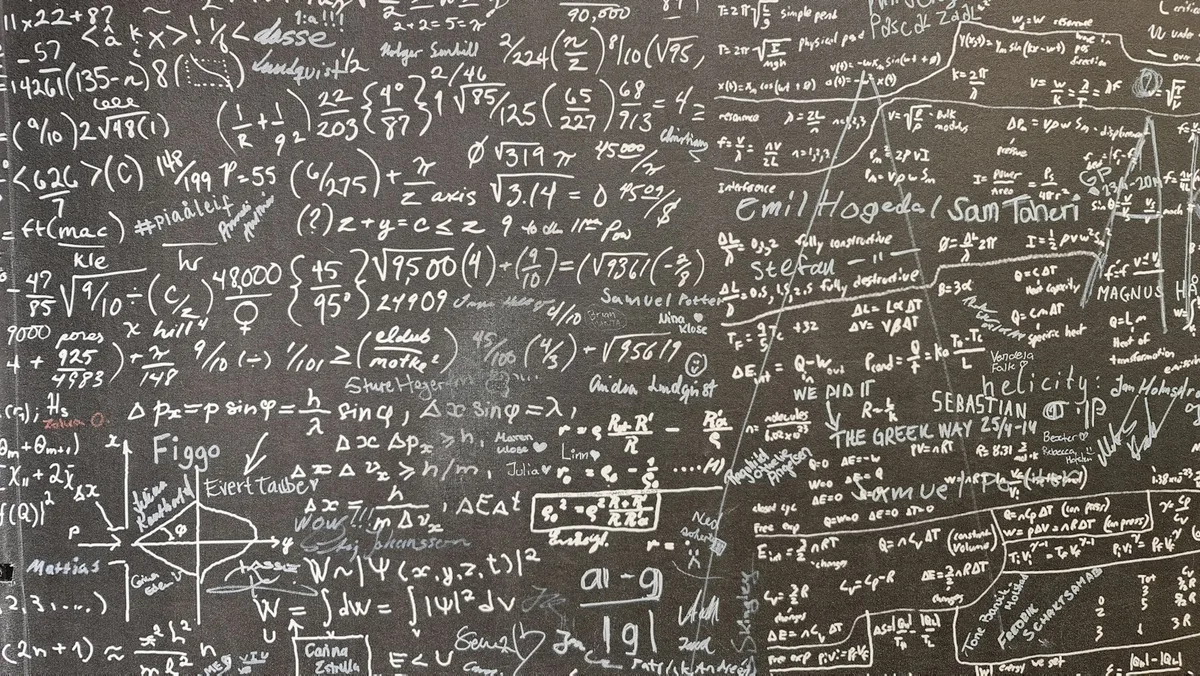 A blackboard covered in handwritten mathematics.